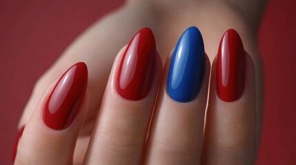 Vibrant Red and Blue Nail Art Design Showing Elegant Hand with Perfectly Shaped Nails