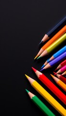 Fototapeta premium Vibrant Colored Pencils Arranged on a Dark Background Ready for Artistic Expression and Creativity