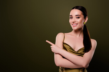 Photo of chic classy lady feel joyful celebrate xmas point empty space discotheque isolated on khaki color background