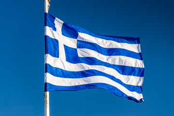 Flag of Greece. Concept photo with the Greek flag waving against clean blue sky.