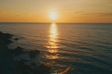 Obraz premium Beautiful sunset over the sea with an orange sky and sun, a summer landscape