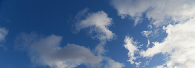 The deep blue sky adorned with white clouds stretches to infinity. Rear background for website, footer for website, header for website