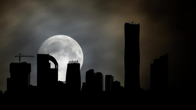 Ethiopia: Silhouette Skyline panorama of city of Addis Ababa, Time Lapse by Night with Full Moon, Africa