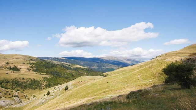 Clouds passing over green hills timelapse in Coll De La Creueta, Barcelona, Spain