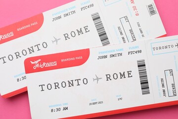 Travel agency. Flight tickets on pink background, top view