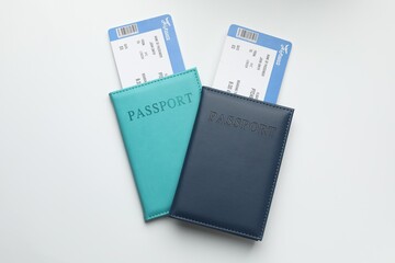 Travel agency. Flight tickets and passports on light background, top view