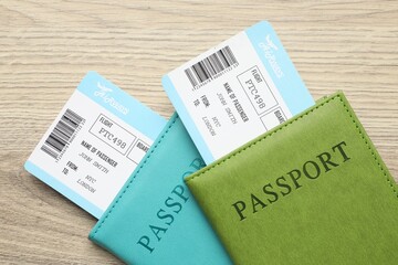 Travel agency. Flight tickets and passports on wooden table, top view