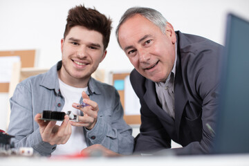 young electronics student with his teacher