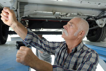 senior man checking a car