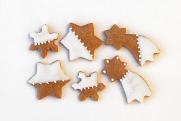 Decorated gingerbread cookies of various shapes on a white background. Christmas baking
