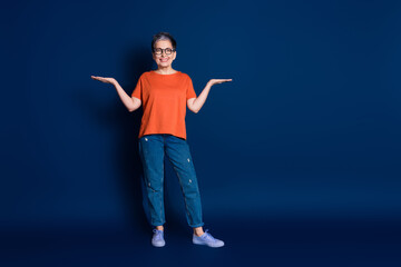 Full length photo of lovely pensioner lady hold compare empty space dressed stylish orange garment isolated on dark blue color background