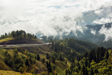 Mountainous view from above on woods and misty sky