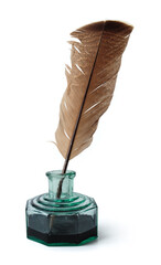 Feather in a green vintage inkwell. Quill pen with a glass bottle of ink.