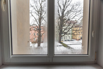 Fototapeta premium Steamy window in the apartment due to moisture and poor ventilation....