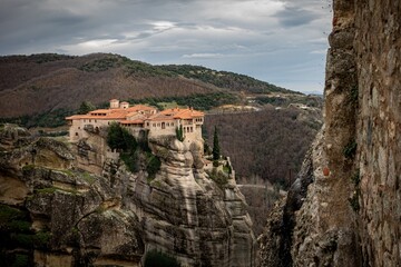 A monastery sits atop a cliff in Meteora. Orthodox Greece landscapes.
