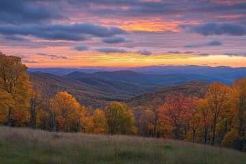 Fototapeta premium Colorful autumn sunset over rolling hills with vibrant foliage in a mountain landscape