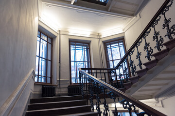 Fototapeta premium Staircase with ornamental bannisters and big windows, Saint-Petersburg, Russia