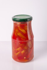 lecho from peppers and tomatoes in a glass jar on a white background, mock-up