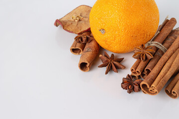orange, cinnamon, anise, ingredients for mulled wine on a white background, copy space