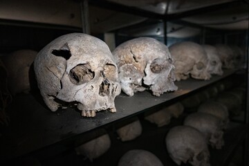 Old Skulls positioned on a shelf in a dark room. Krupanj church. Serbia