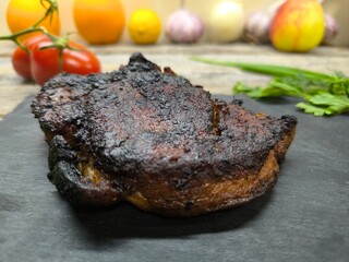 Delicious fried steak on a granite edged board