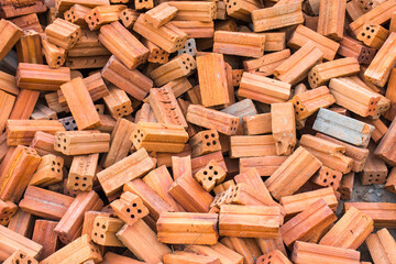 Pile red bricks texture background.