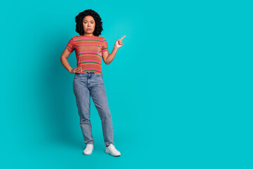 Full size photo of pretty young girl direct finger empty space isolated on teal color background
