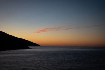 A stunning sunset over a calm Mediterranean sea. Mount Athos. Greece.