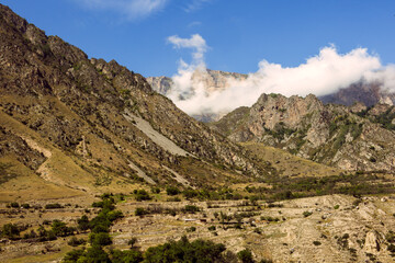 Caucasus, mountainous rocky view, blue sky with white cottony clouds