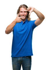 Fototapeta premium Young handsome man with long hair over isolated background smiling making frame with hands and fingers with happy face. Creativity and photography concept.