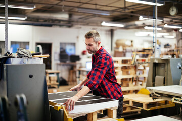 Male factory worker working in industrial printing office