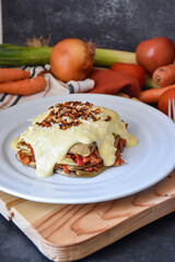homemade recipe of vegetarian lasagna dish with bechamel sauce and fresh ingredients.