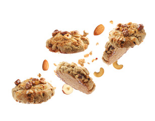Yummy nut cookies in air on white background