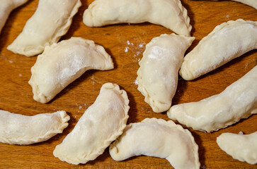 Raw handmade dumplings, pelmeni on a cutting board