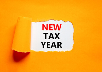New tax year symbol. Concept words New tax year on beautiful white paper. Beautiful orange table orange background. Business new tax year concept. Copy space.