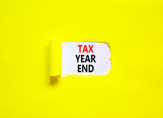Tax year end symbol. Concept words Tax year end on beautiful white paper. Beautiful yellow table yellow background. Business tax year end concept. Copy space.
