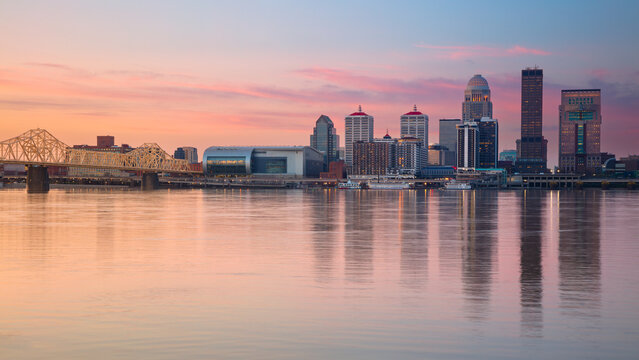 Louisville, Kentucky, USA. Cityscape image of Louisville, Kentucky, USA downtown skyline with reflection of the city the Ohio River at spring sunrise.