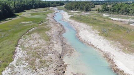 Fototapeta premium Aerial View Turquoise River Flowing Through Dry Landscape