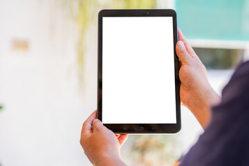 Hand of a person holding a tablet with a transparent screen, cut out for cropping