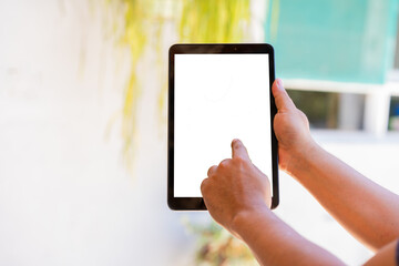 Hand of a person touching a transpartent screen of a tablet, cut out