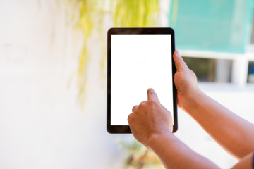 Hand of a person touching a transpartent screen of a tablet, cut out