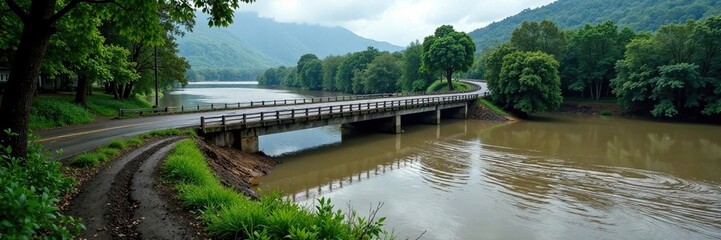 Road bridge partially submerged in murky floodwaters, erosion, bridges