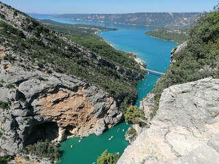 Stunning aerial view of the Verdon Gorge in summer, showcasing its dramatic cliffs and turquoise waters. Perfect for illustrating breathtaking landscapes, natural beauty, and outdoor adventure.