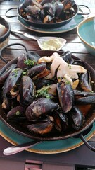 Very tasty freshly cooked mussels in a restaurant in the fresh air 