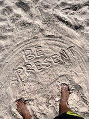 be present, text in the sand, beach time, motivational phrase
