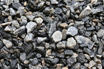 Close up view of a pile of crushed concrete stones that has been wet
