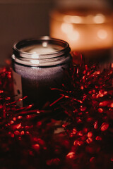 red candle and christmas decorations