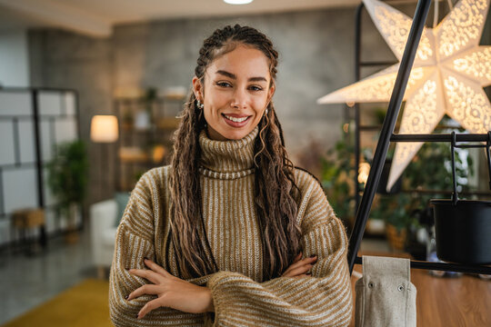 portrait of pretty young woman with arm crossed in the living room