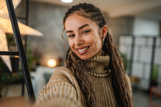beautiful smiling young woman take a self portrait and pose at home