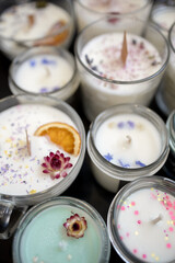 A set of different aroma Soy and coconut wax candles in glass jars. Scented candle. Natural essential candles in a Amber jar. Aromatherapy, wellness and relax in spa product. Close up.